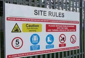 Magnetic site rules sign attached to a metal fence 